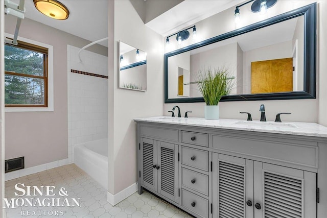 bathroom with vanity and tiled shower / bath combo