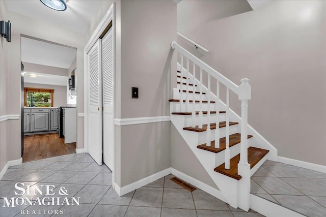 stairs featuring tile patterned flooring