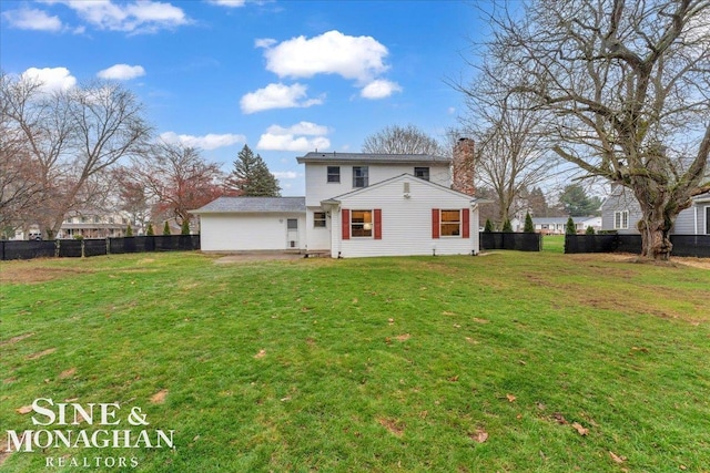 rear view of property with a lawn