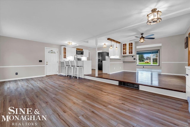 interior space featuring hardwood / wood-style floors, ceiling fan, and sink