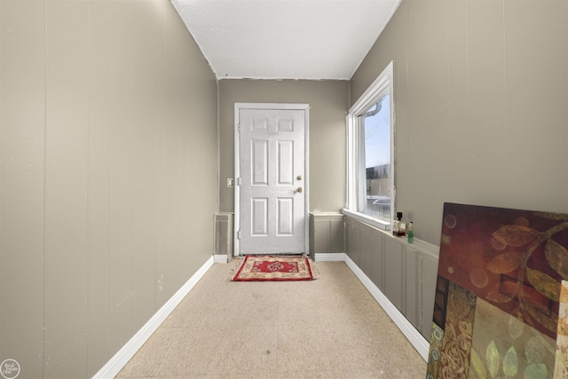 entryway with wooden walls