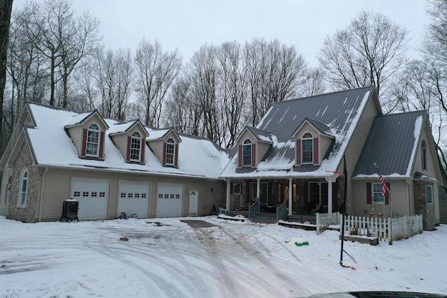 cape cod home with a porch and a garage