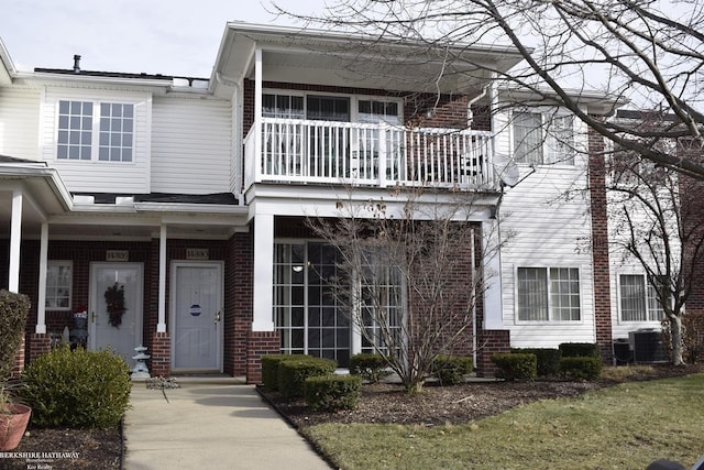 view of front of property with a balcony and central air condition unit