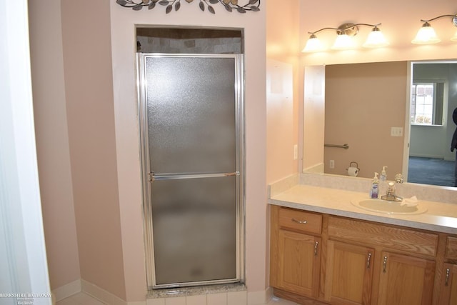 bathroom with vanity and a shower with door