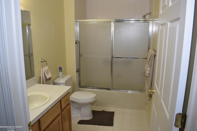 full bathroom featuring tile patterned flooring, vanity, shower / bath combination with glass door, and toilet