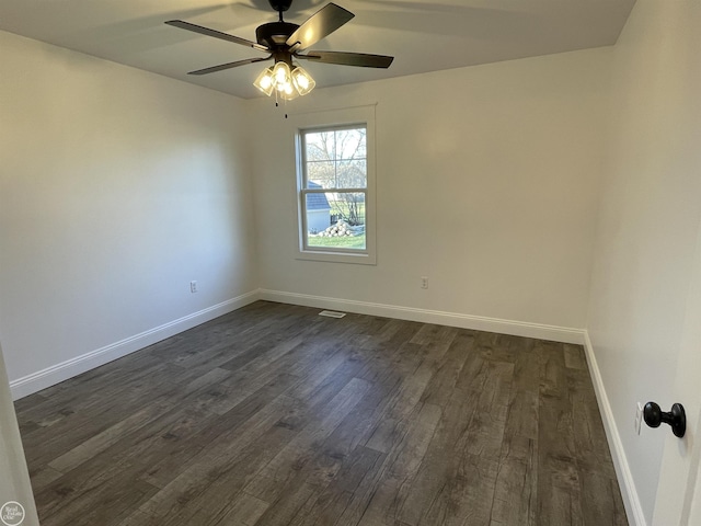 spare room featuring dark hardwood / wood-style floors and ceiling fan