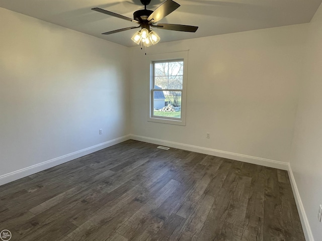 unfurnished room with ceiling fan and dark hardwood / wood-style flooring