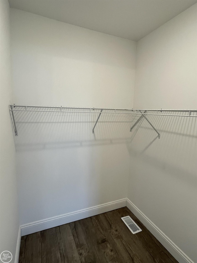 walk in closet featuring dark hardwood / wood-style floors