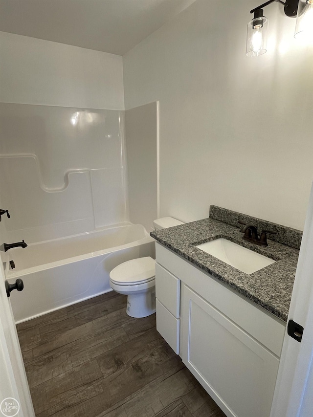 full bathroom with toilet, vanity, tub / shower combination, and hardwood / wood-style flooring