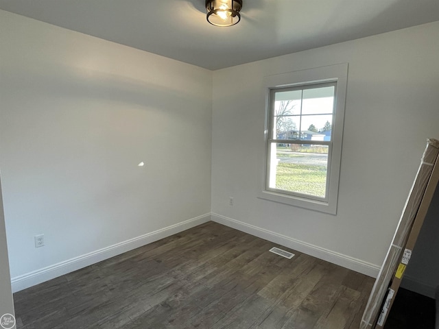 spare room with dark wood-type flooring