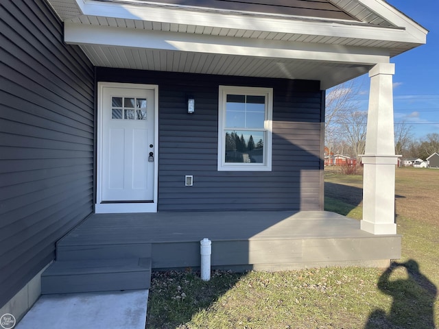 view of exterior entry featuring covered porch