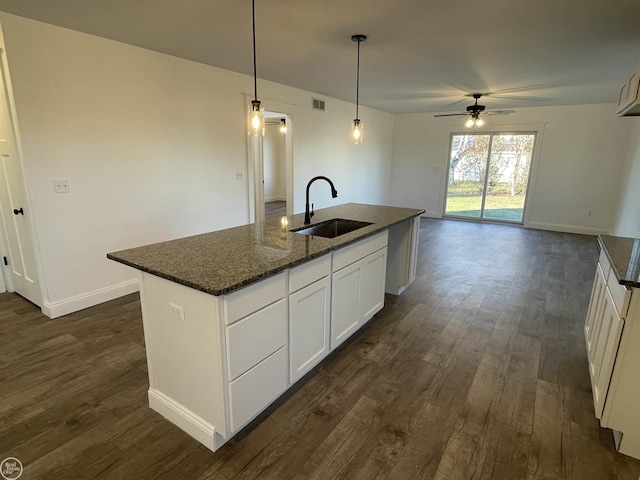 kitchen featuring a center island with sink, ceiling fan, pendant lighting, and sink