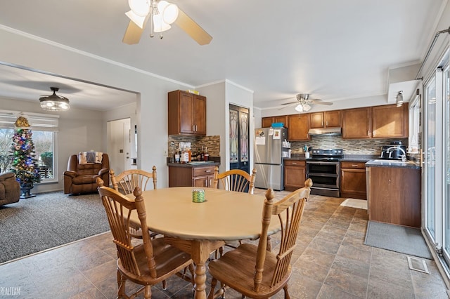 dining room with carpet flooring, ornamental molding, and sink