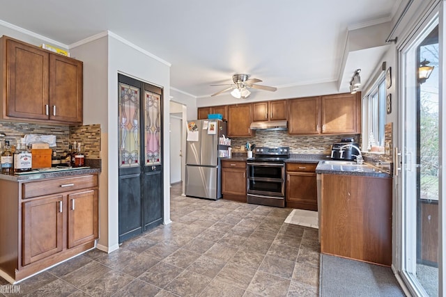 kitchen featuring appliances with stainless steel finishes, tasteful backsplash, ornamental molding, ceiling fan, and sink