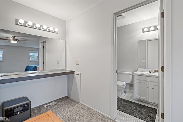 bathroom with ceiling fan, vanity, and toilet