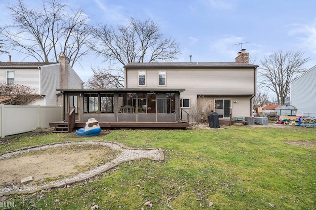 back of house with a sunroom, cooling unit, and a lawn