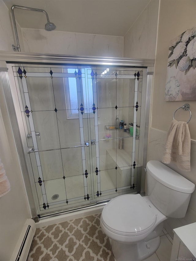 bathroom featuring tile patterned flooring, toilet, a shower with shower door, and a baseboard heating unit