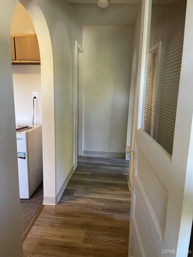 hallway with dark wood-type flooring