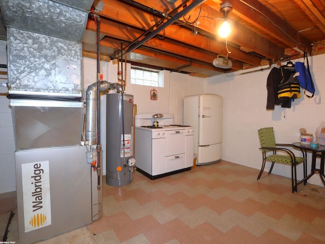 basement with heating unit, white fridge, gas water heater, and washer / dryer