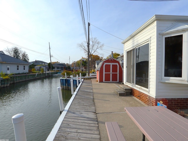 view of dock featuring a water view and a patio