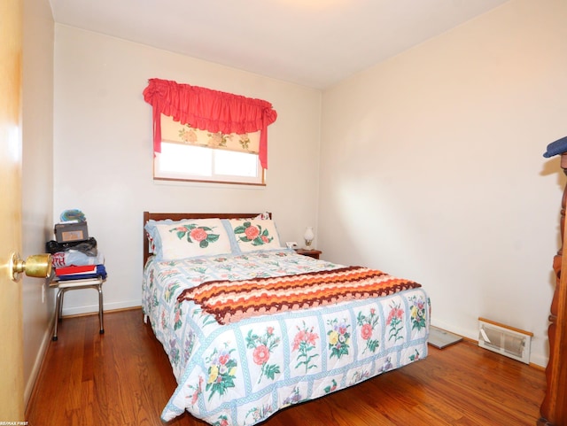 bedroom with hardwood / wood-style floors