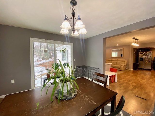 dining area featuring a notable chandelier