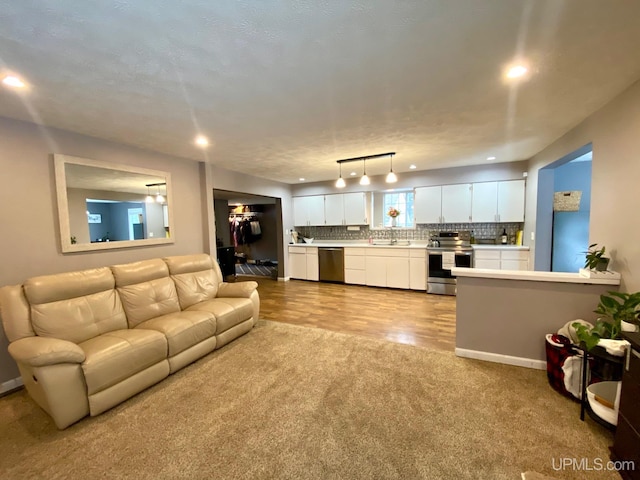 living room with light carpet and sink