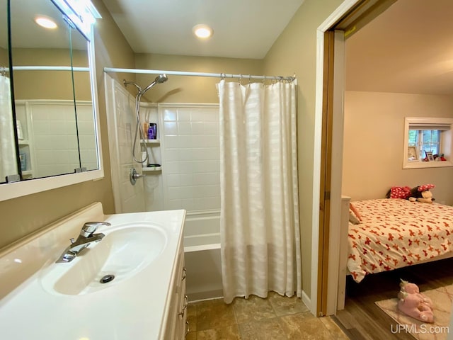 bathroom with shower / bathtub combination with curtain and sink