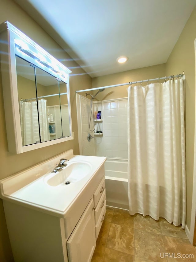 bathroom featuring vanity and shower / bath combo with shower curtain