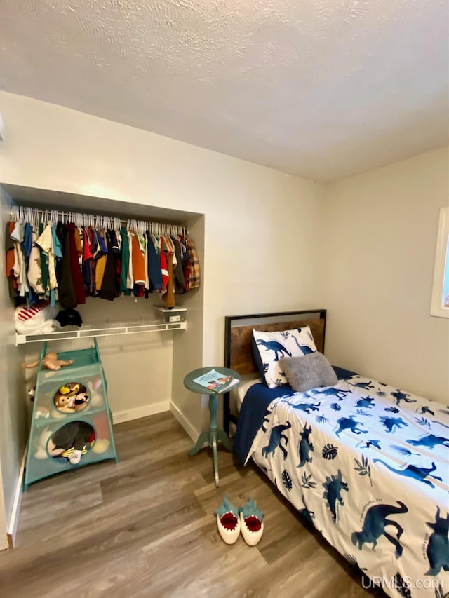 bedroom with hardwood / wood-style floors