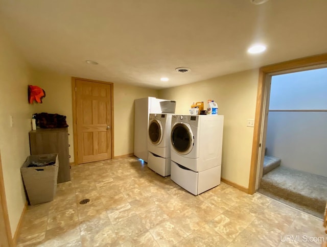 clothes washing area featuring washer and dryer