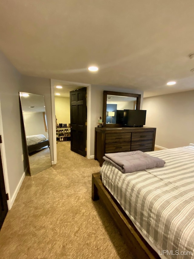 bedroom featuring light carpet