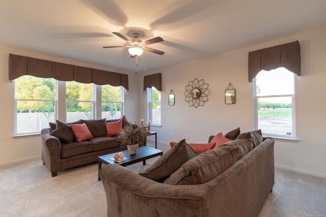 carpeted living room with ceiling fan and a healthy amount of sunlight