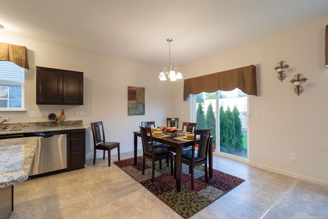 dining space with a chandelier and sink