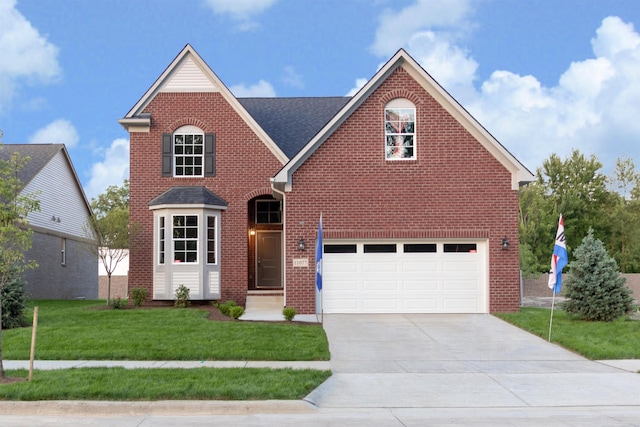 view of property featuring a front yard and a garage