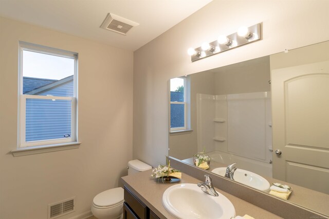 full bathroom with bathtub / shower combination, vanity, and toilet