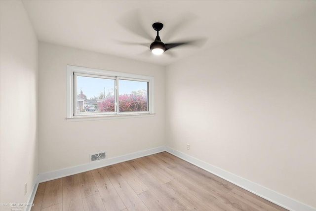 empty room with ceiling fan and light hardwood / wood-style floors