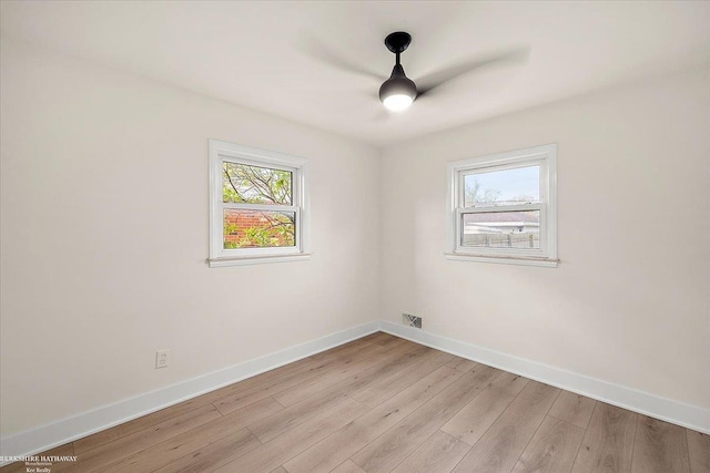 spare room featuring light hardwood / wood-style flooring and ceiling fan