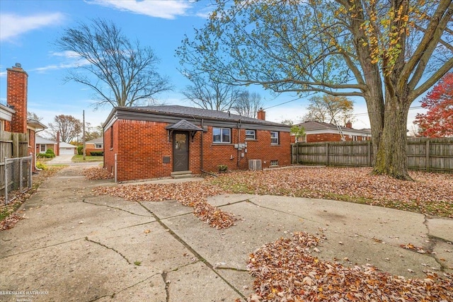 rear view of property featuring central AC unit