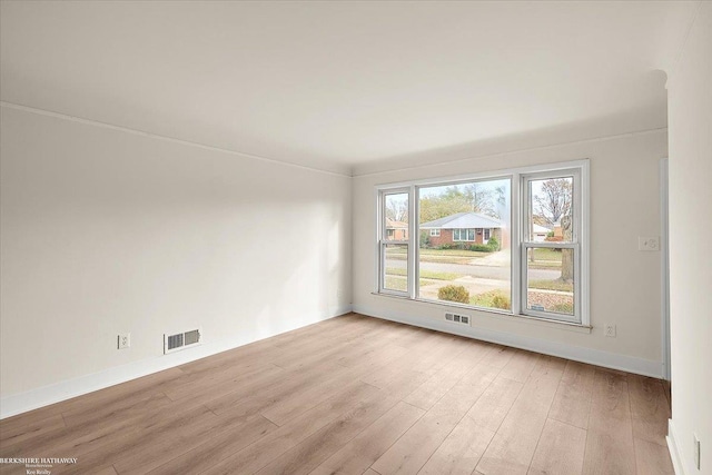 empty room with light hardwood / wood-style floors