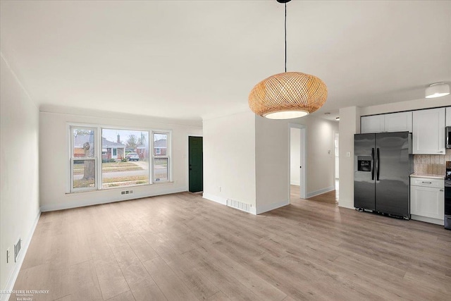 unfurnished living room featuring light hardwood / wood-style flooring