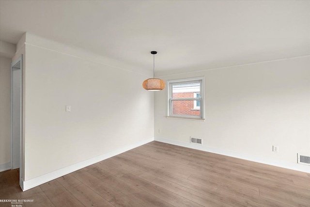 unfurnished room with hardwood / wood-style flooring