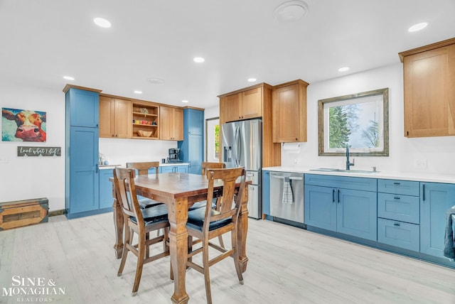 dining room with sink and light hardwood / wood-style flooring