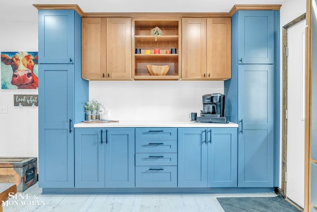 kitchen featuring light hardwood / wood-style floors and blue cabinetry