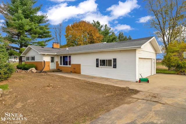 rear view of property featuring a garage