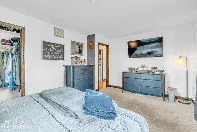 carpeted bedroom with a closet