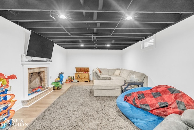 living room with wood-type flooring and a fireplace