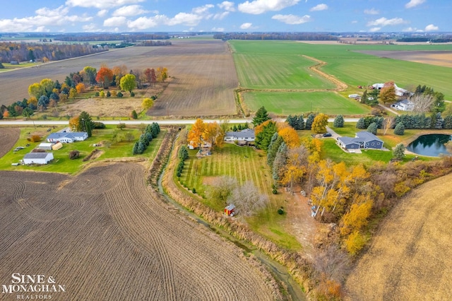 drone / aerial view featuring a rural view and a water view