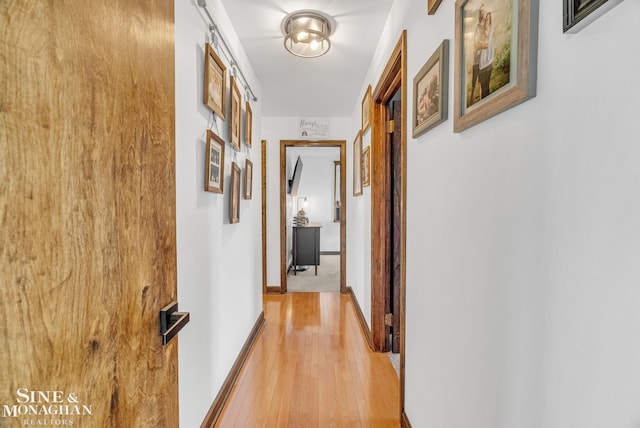 corridor with light hardwood / wood-style flooring