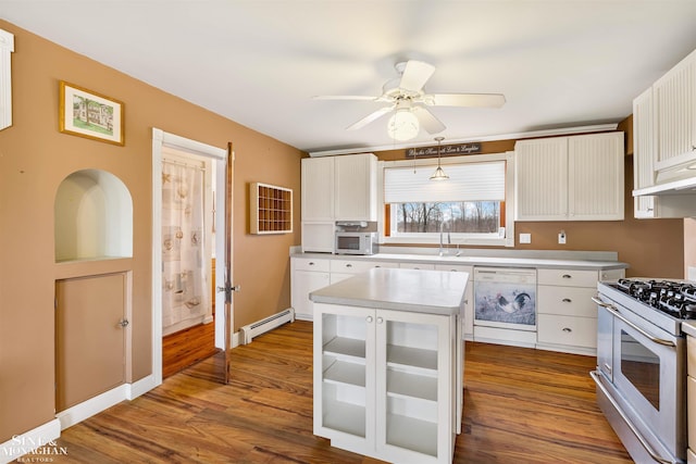 kitchen with white cabinetry, a baseboard heating unit, pendant lighting, white appliances, and a kitchen island